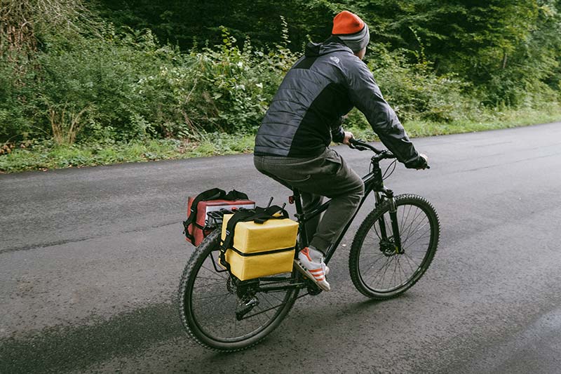 DJ Oonops cycling with his panniers for records