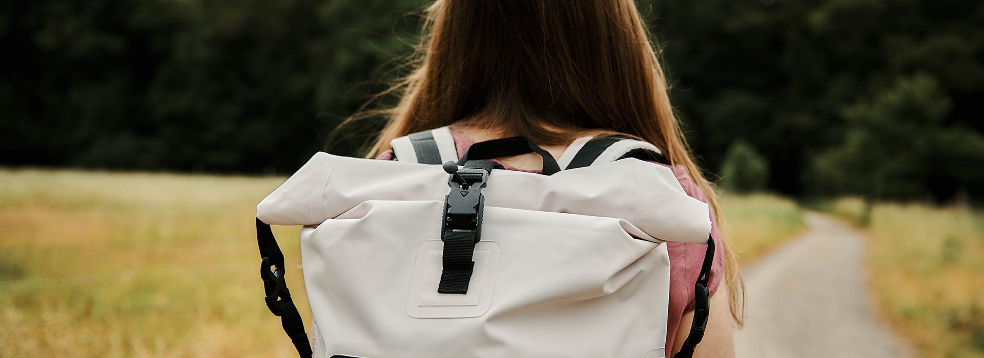 Woman from behind - close-up of the buckle on her backpack