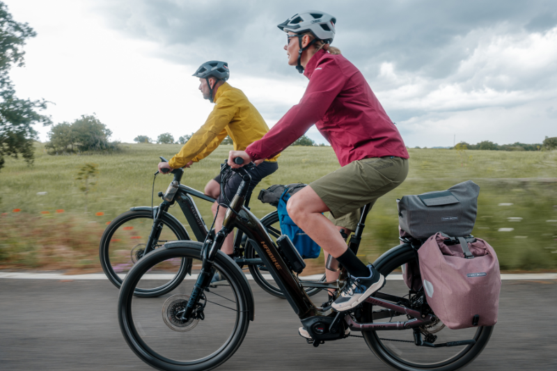 man and woman riding ebikes