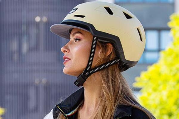 Headshot of a woman wearing a Xnito helmet with FIDLOCK helmet buckle