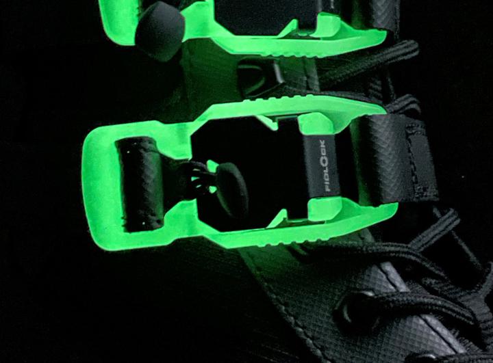 Close-up of a shoe with the glow-in-the-dark V-BUCKLE in the dark