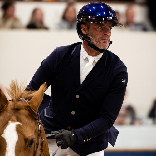 Gregory Cottard riding a horse and wearing a NACA helmet 