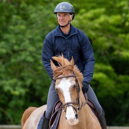 Karim Laghouag riding a horse wearing a NACA helmet